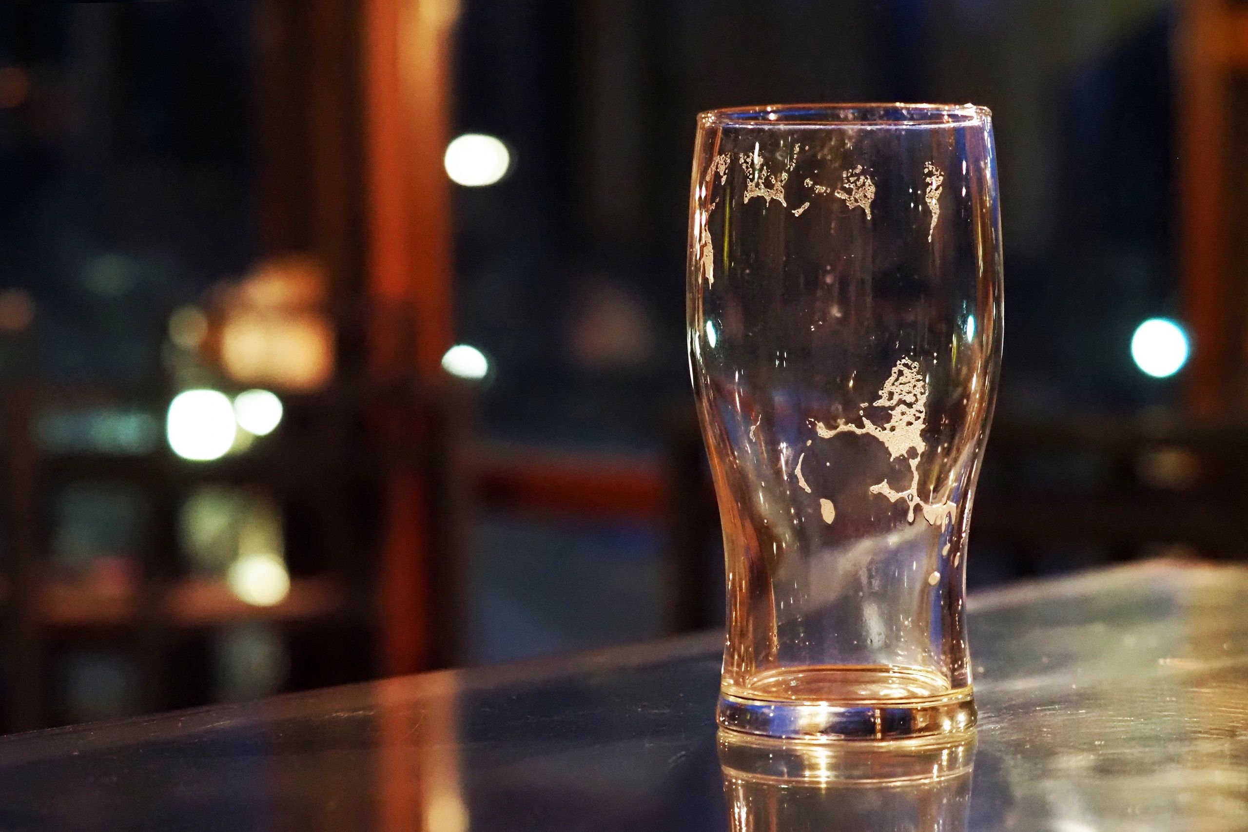 Beer glass on a table in a pub